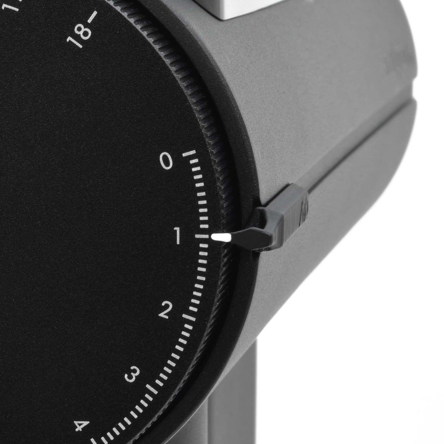 Angled close-up front view of a Timemore Sculptor 078 espresso grinder dial with custom dial pointer attached.
