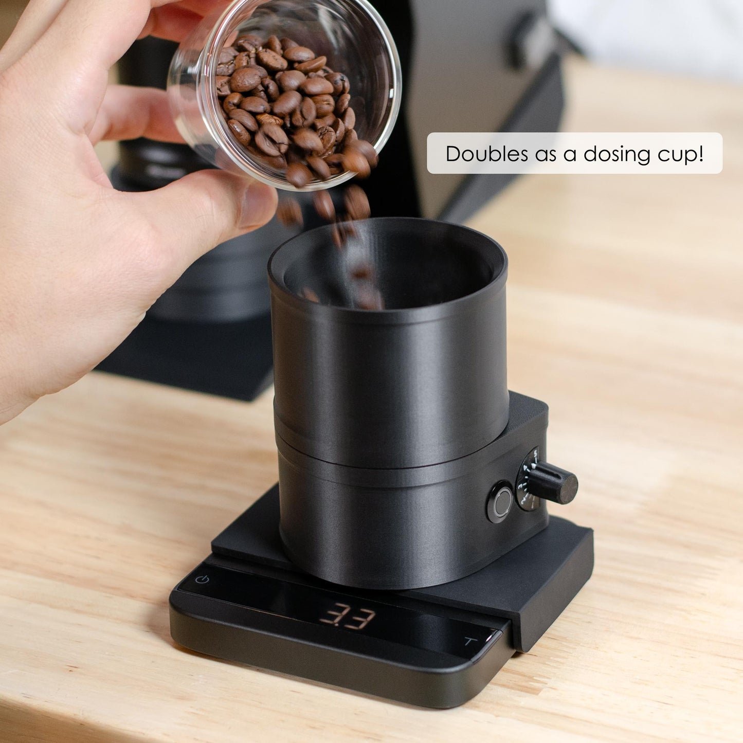 ARO Slow Feeder black PLA coffee bean feeder used as a dosing cup on a scale while coffee beans are poured into the hopper