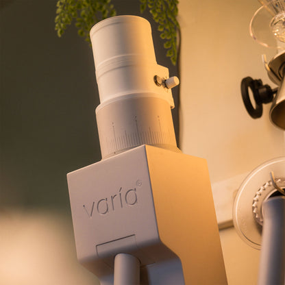 White ARO Espresso slow feeder attached to a Varia VS6 grinder, shown from a low angle.