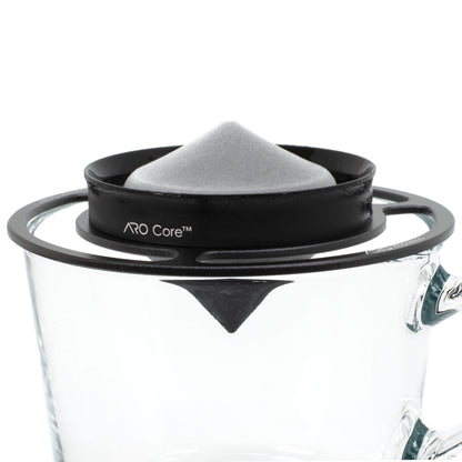 Close-up of frozen ARO Core extract chiller on a glass cup, highlighting its unique shape and efficient heat transfer properties.